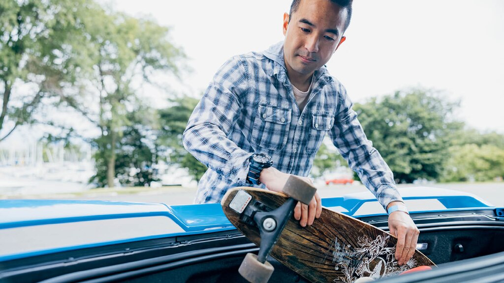 Ken Kuevibulvanich saca una tabla de skate de la cajuela de su Corvette 2020.